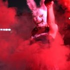 Pink bunny-eared rabbit in red smoke on dark background