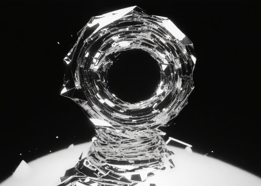 Monochrome image of shattered glass ring on dark background