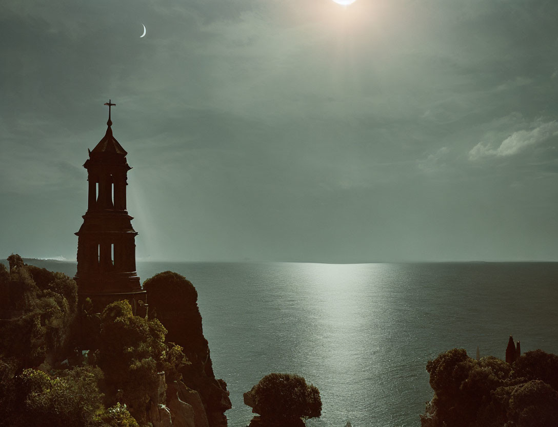 Bell tower on cliff with sunlight, hazy sky, and crescent moon