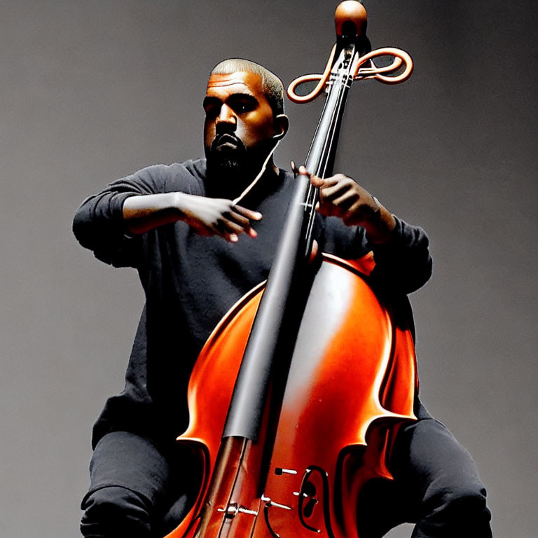 Intense person playing large orange cello on grey background
