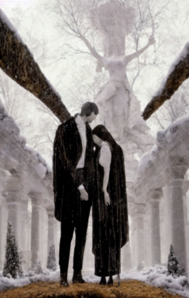 Formal couple embracing in snowy landscape with classical columns