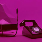 Vintage rotary phone and brick cell phone on purple backdrop with geometric sculpture and reflective sphere.