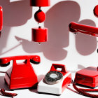 Classic Red Rotary Telephones with Off-Hook Handset on White Background