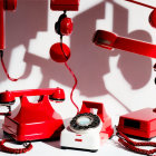 Vintage Red Telephones and Answering Machines with Shadows on White Background