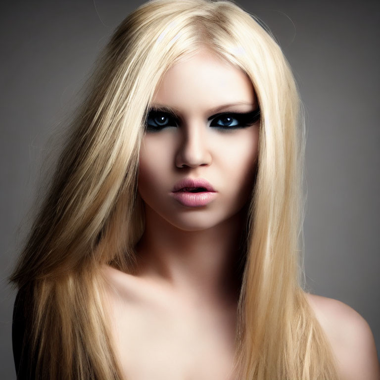 Blonde person with smoky eye makeup on gray background
