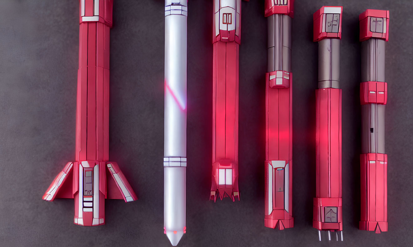 Five Red and White Toy Rockets on Dark Grey Surface