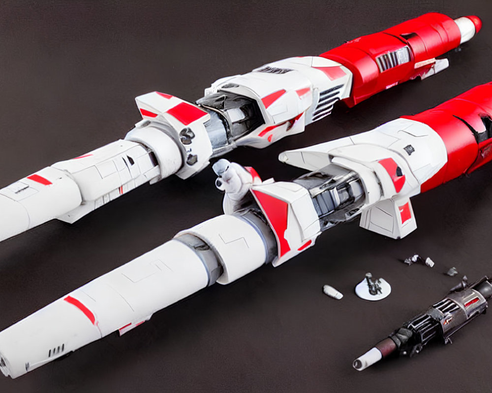 Detailed Red and White Model Spaceships Next to Dismantled Craft