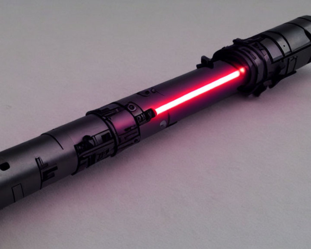 Black Hilt Lightsaber with Glowing Red Blade on Light Grey Background