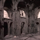 Abandoned building interior with arches, damaged walls, sunlight, and debris