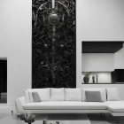 Monochrome living room with white sofa and black wall relief