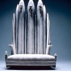Ornate sculptural throne with pointed elements on blue background