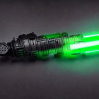 Detailed Black Sci-Fi Laser Gun Emitting Bright Green Beam
