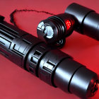 Black futuristic handcuffs with red lights on red background, linked by chain