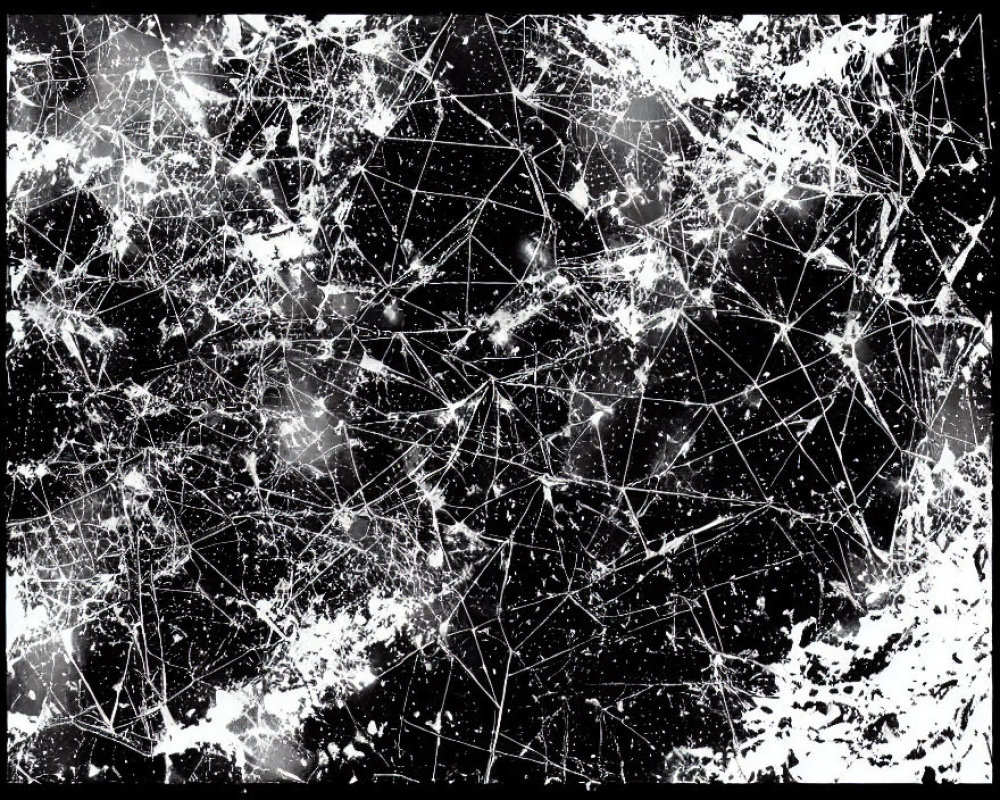 Abstract black and white artwork with chaotic lines and splatters depicting a network or shattered glass