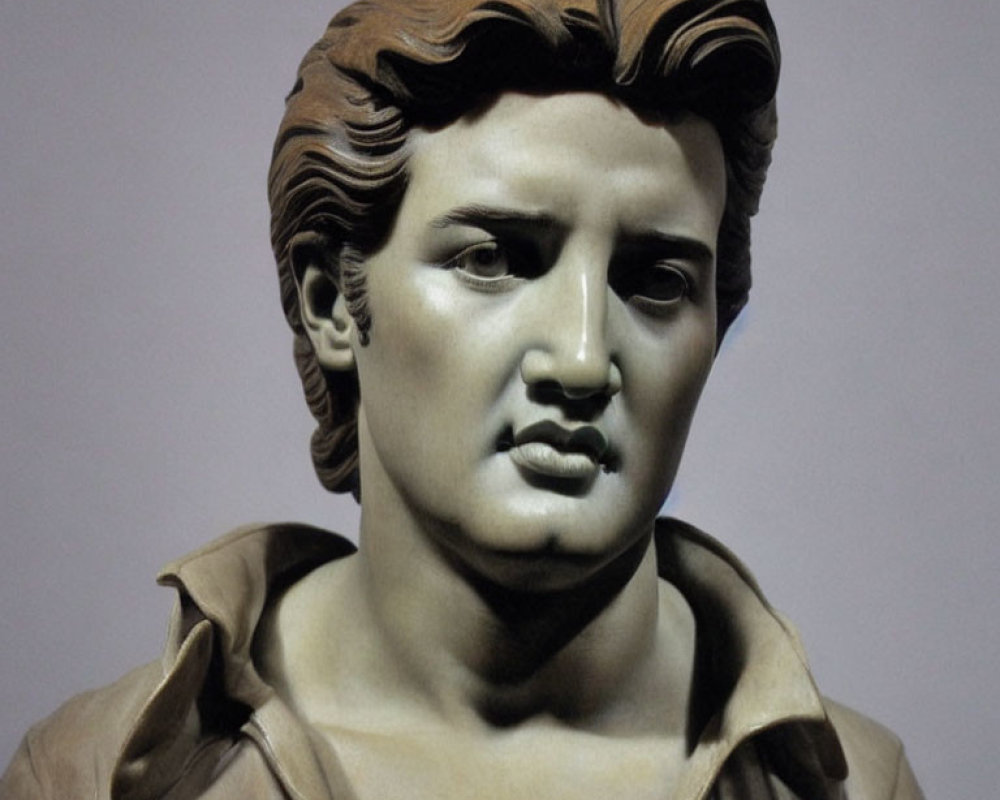 Male bust sculpture with wavy hair and intense gaze in classic style