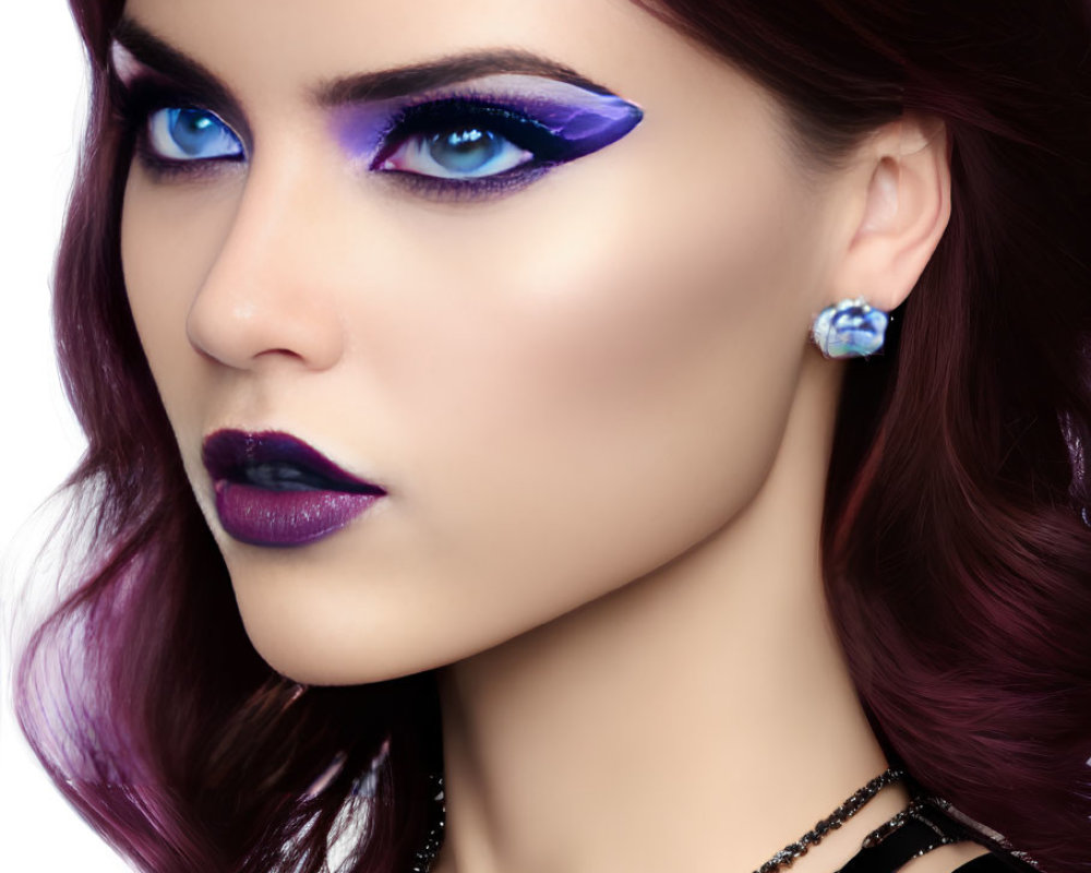 Woman with Blue Eyes, Purple Eye Makeup, Dark Lipstick, and Gemstone Earring