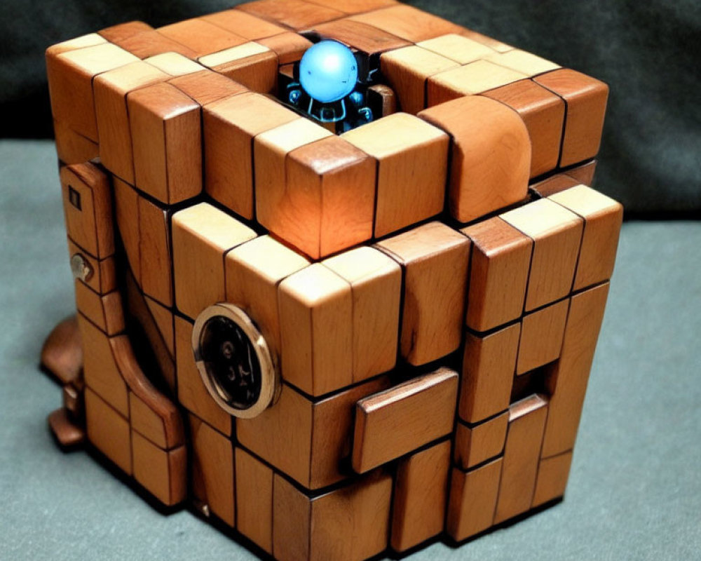 Wooden Puzzle Cube with Blue Figurine on Dark Background