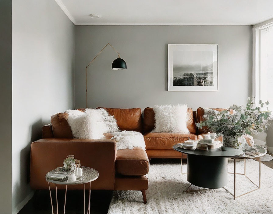 Tan Leather Sofa, White Pillows, Black Coffee Table in Cozy Living Room