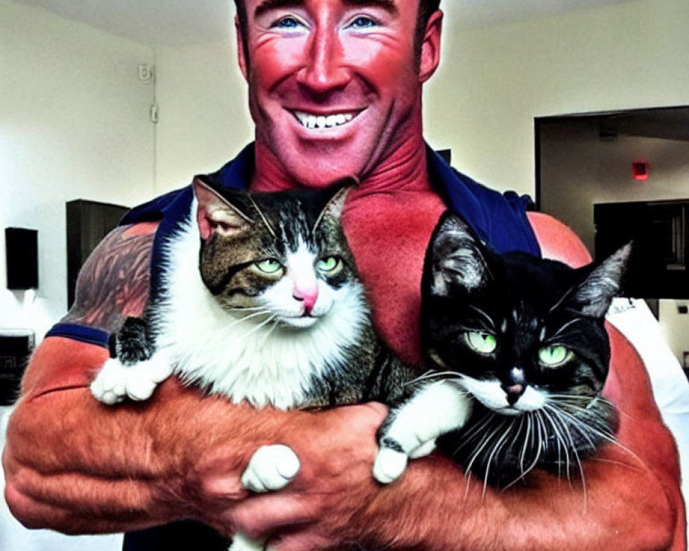 Smiling man with tanned skin holding two cats with unique facial markings