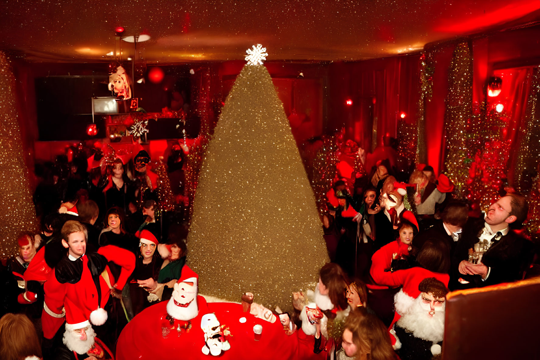 Festive crowd in Santa hats at Christmas party with large tree