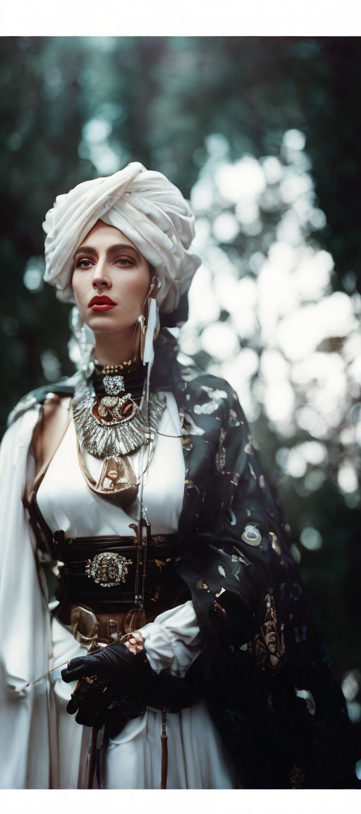Elaborate White Turban Woman with Dramatic Eye Makeup in Forest Setting