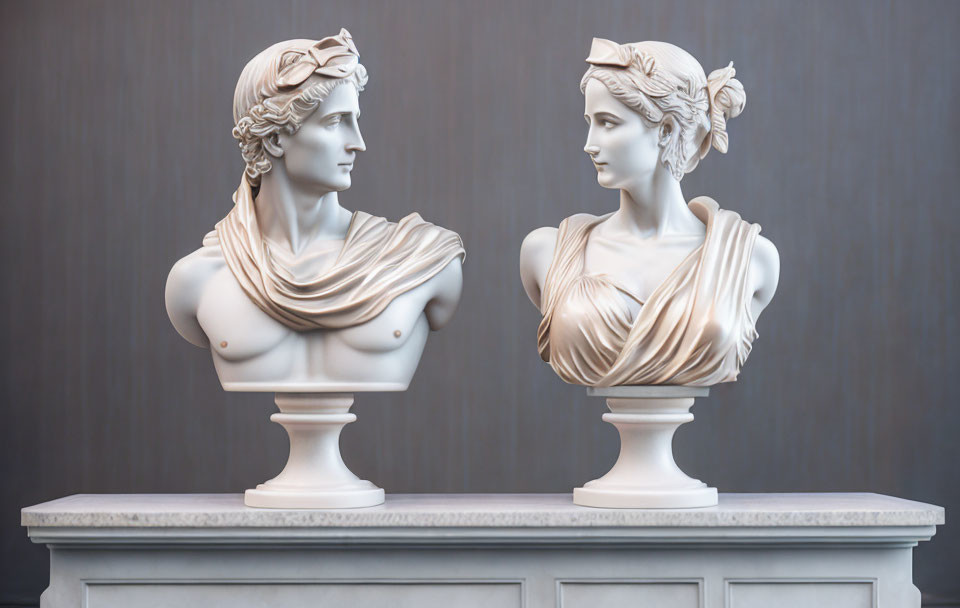 Classical marble busts of mythological figures on pedestal against grey background
