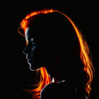 Profile of woman with rim light on dark background