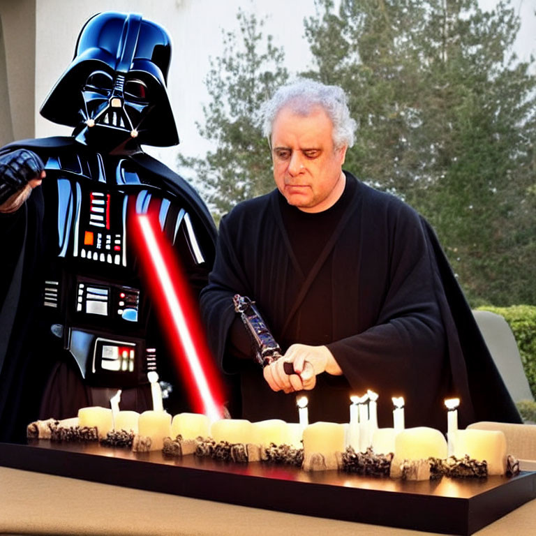 Person in Darth Vader costume with lightsaber beside man lighting candles