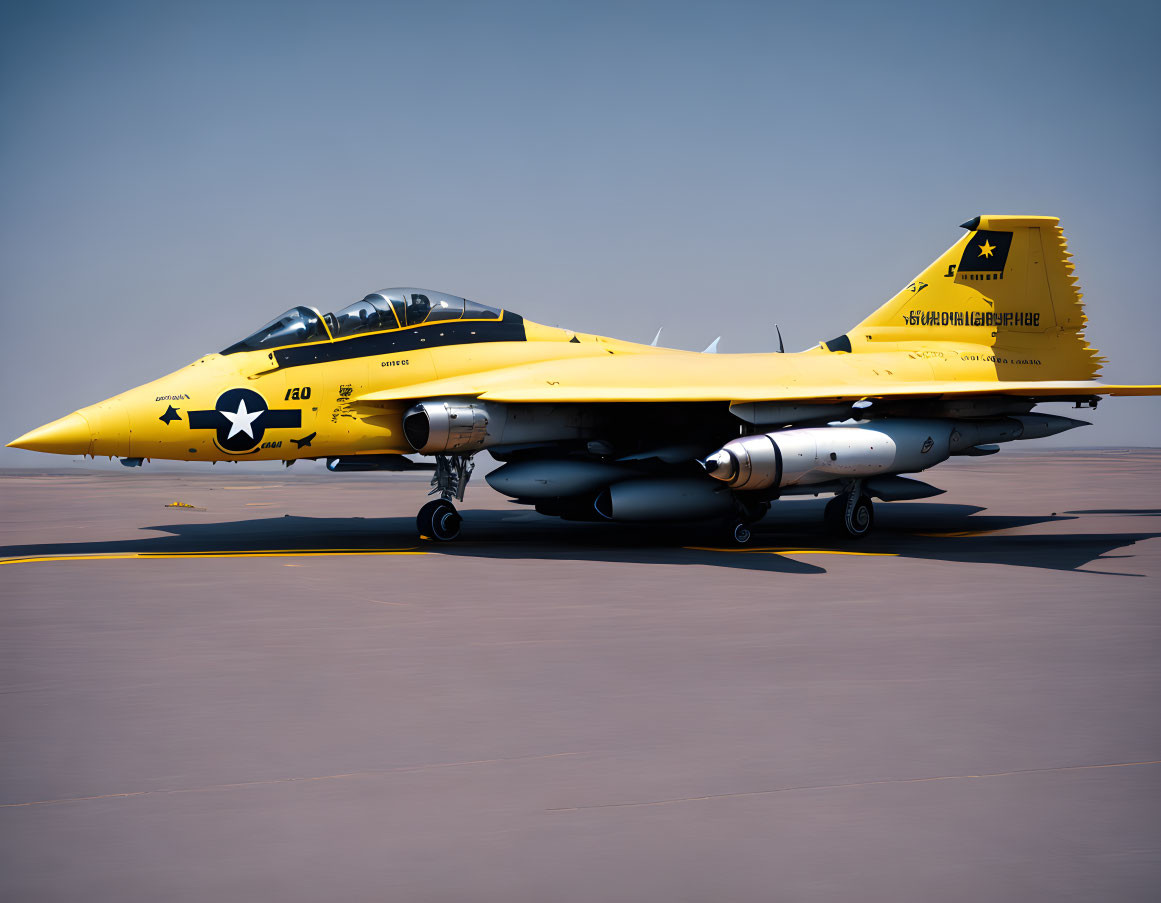 Bright yellow military jet with black insignias parked on tarmac