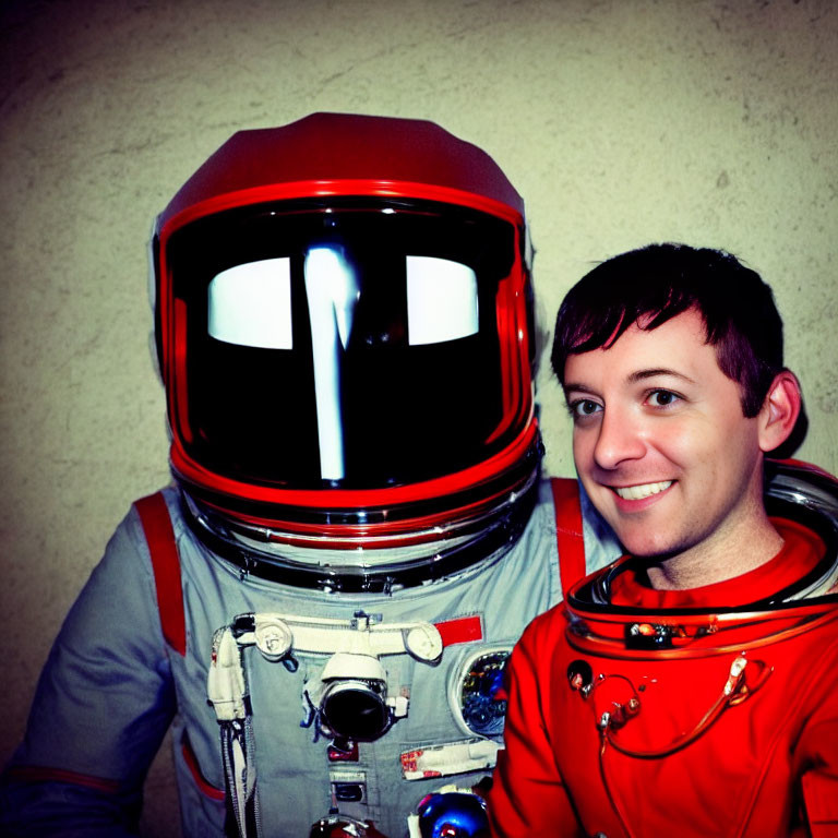 Spacesuit Person with Red Helmet Smiling Against Textured Wall