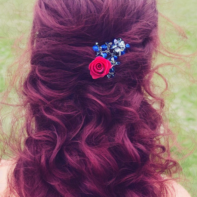Wavy Burgundy Hair with Floral Hair Accessory on Green Background
