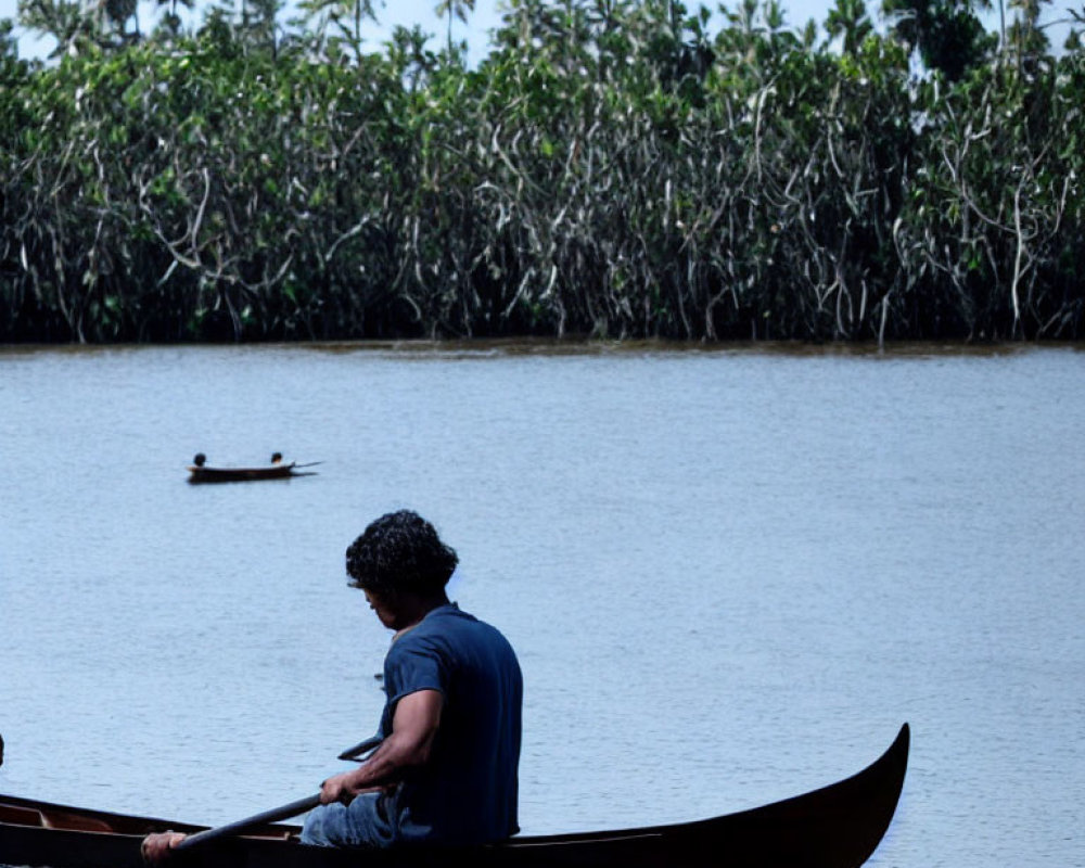 Canoe paddling on calm river, mangrove trees backdrop, second canoe afar