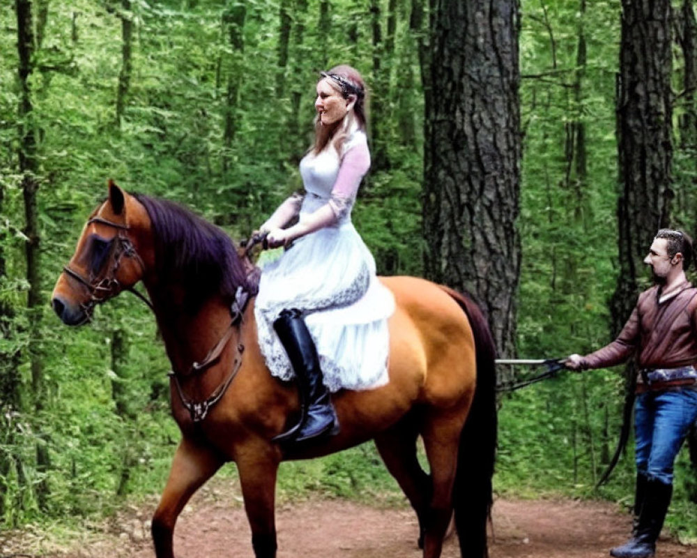 Bride in white dress on horse led by man in leather jacket through forest