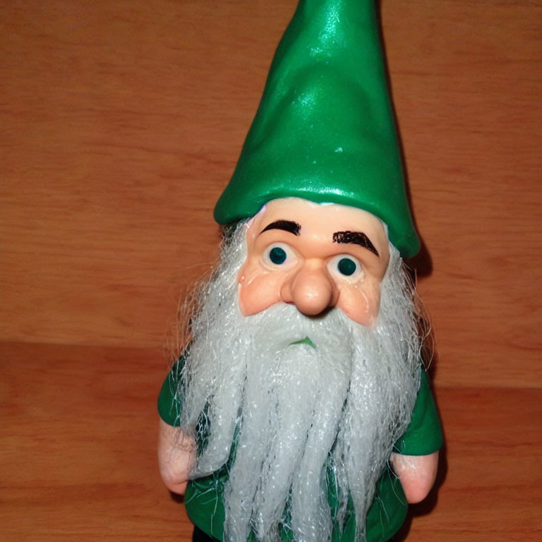 Green-hat Garden Gnome Figurine on Wooden Background