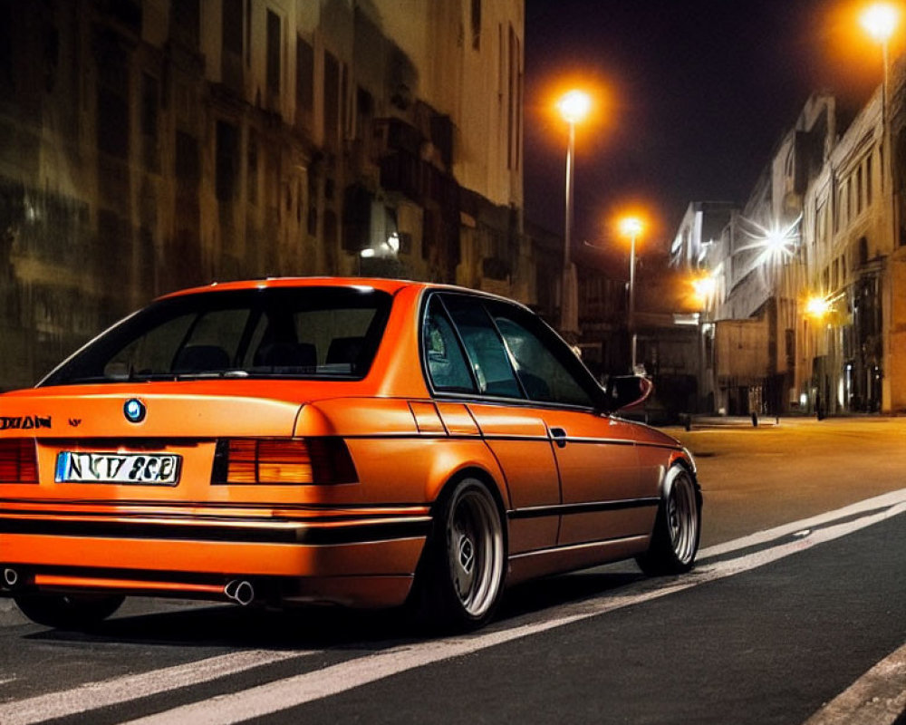 Orange BMW Car Parked on Urban Street at Night