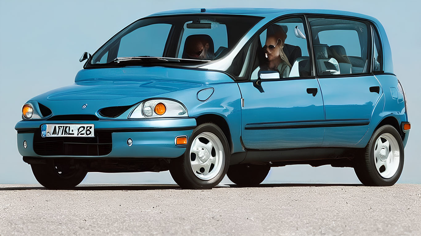 Blue compact hatchback car with two adults wearing sunglasses parked on asphalt under clear sky