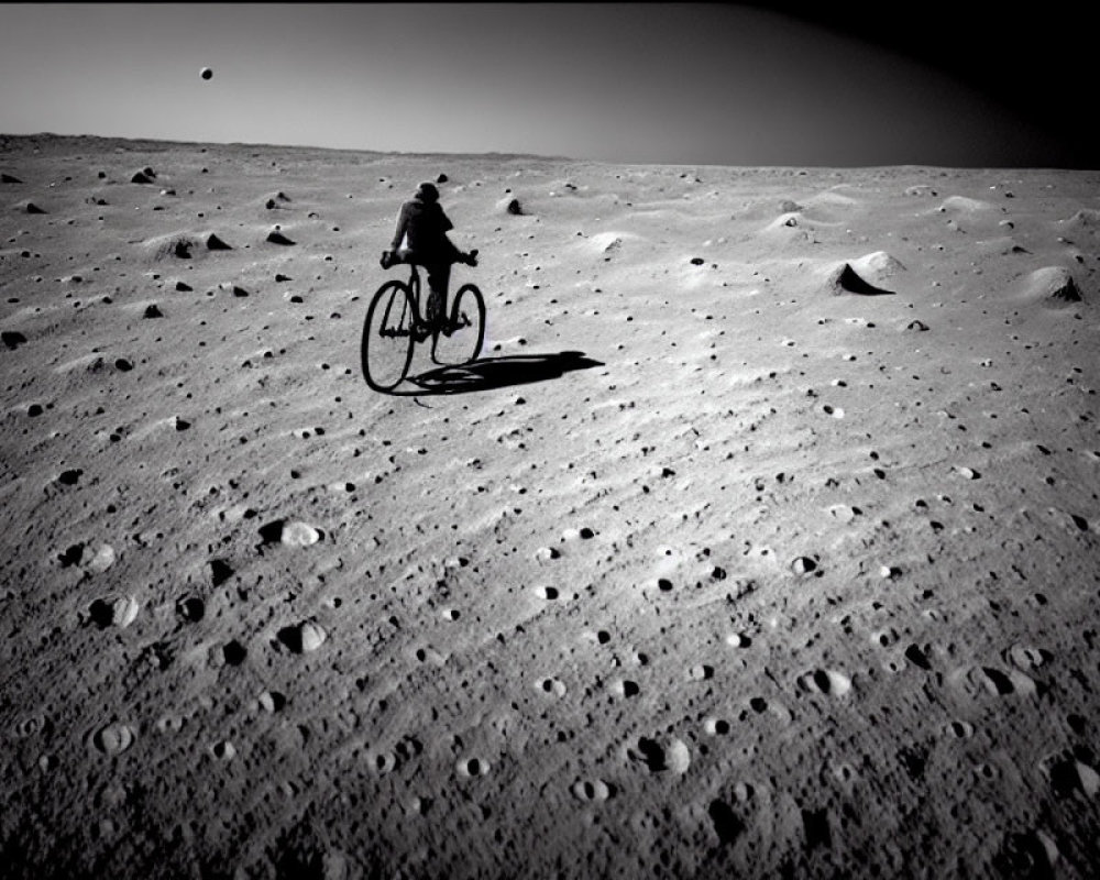 Lonely figure biking on moon-like terrain under dark sky