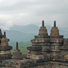 Buddhist temple stupas in misty mountain forest