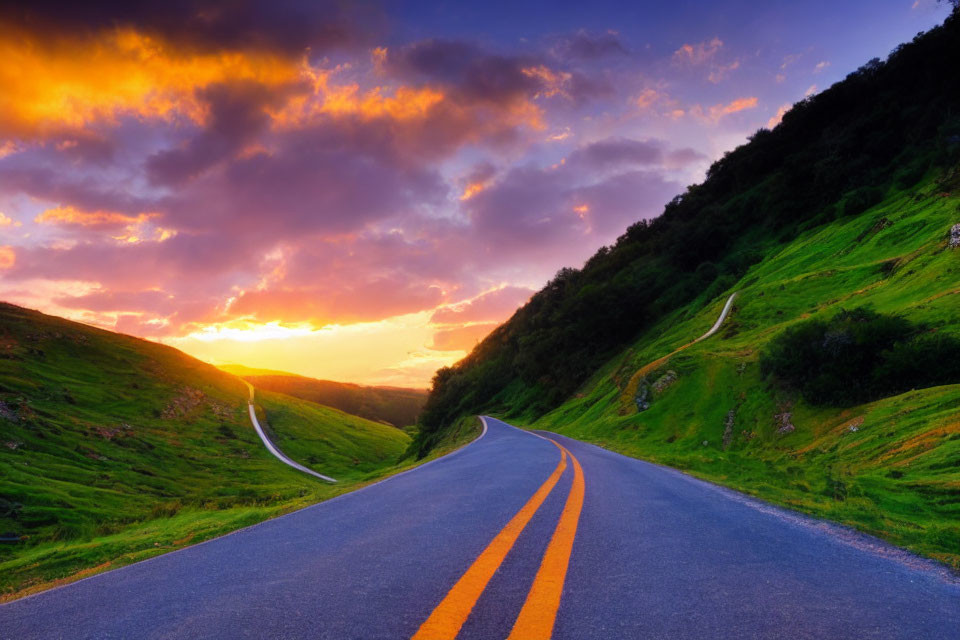 Scenic sunset over lush green hills on winding road