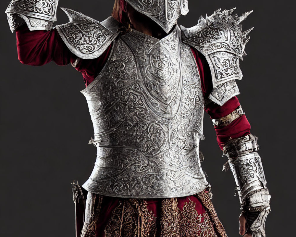 Medieval armor with engraved details and red tunic.
