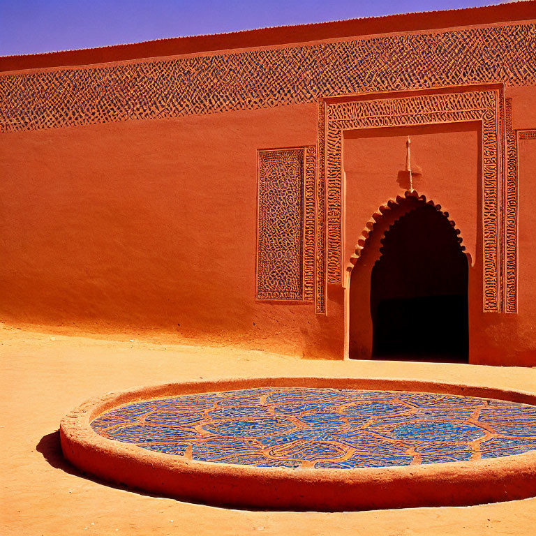 Orange Wall with Arch, Intricate Patterns, and Blue Mosaic Fountain in Sunny Courtyard