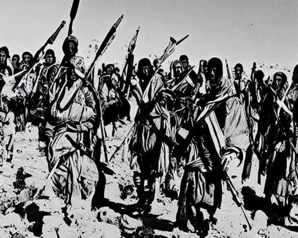 Traditional attired group marching with raised spears under clear sky