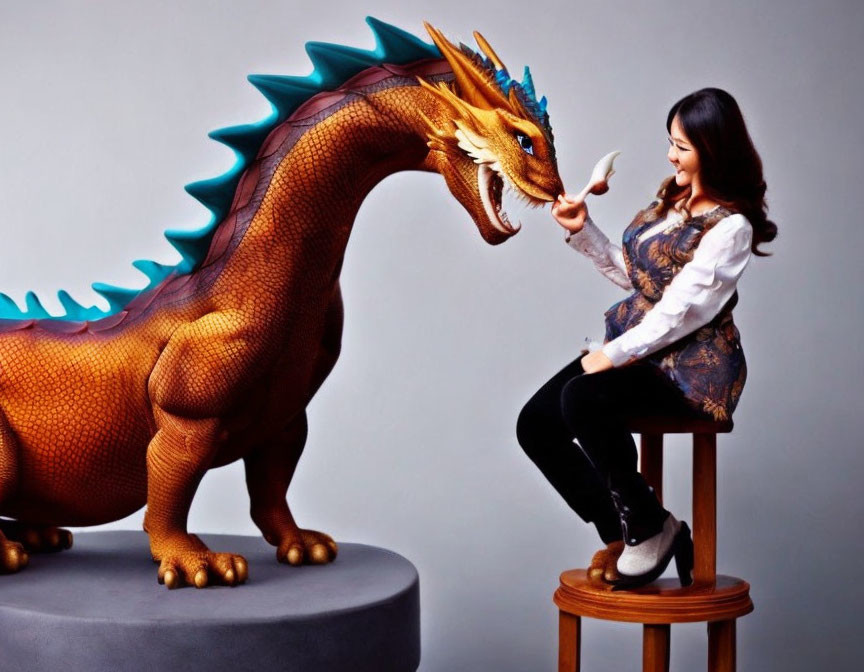 Smiling woman with realistic dragon model on stool