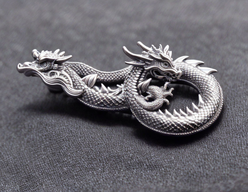 Intricate Metallic Dragon Figurine on Black Textured Background