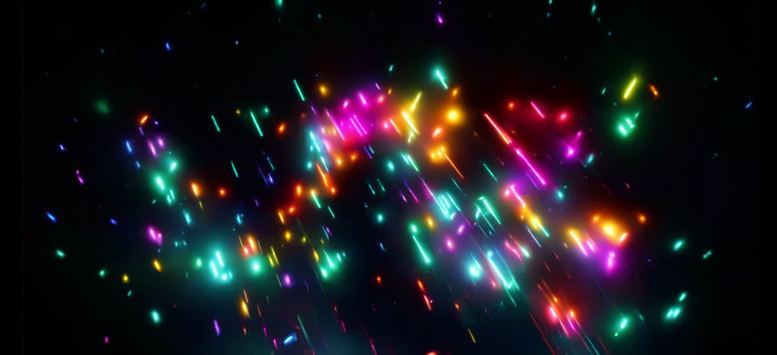 Vibrant multicolored light particles on dark background - dynamic bokeh effect