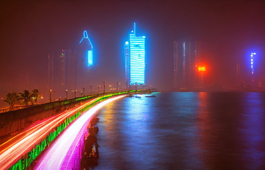 Colorful illuminated skyscrapers in vivid nighttime cityscape by waterfront promenade.