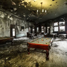 Abandoned billiard hall with dusty pool tables and chandelier