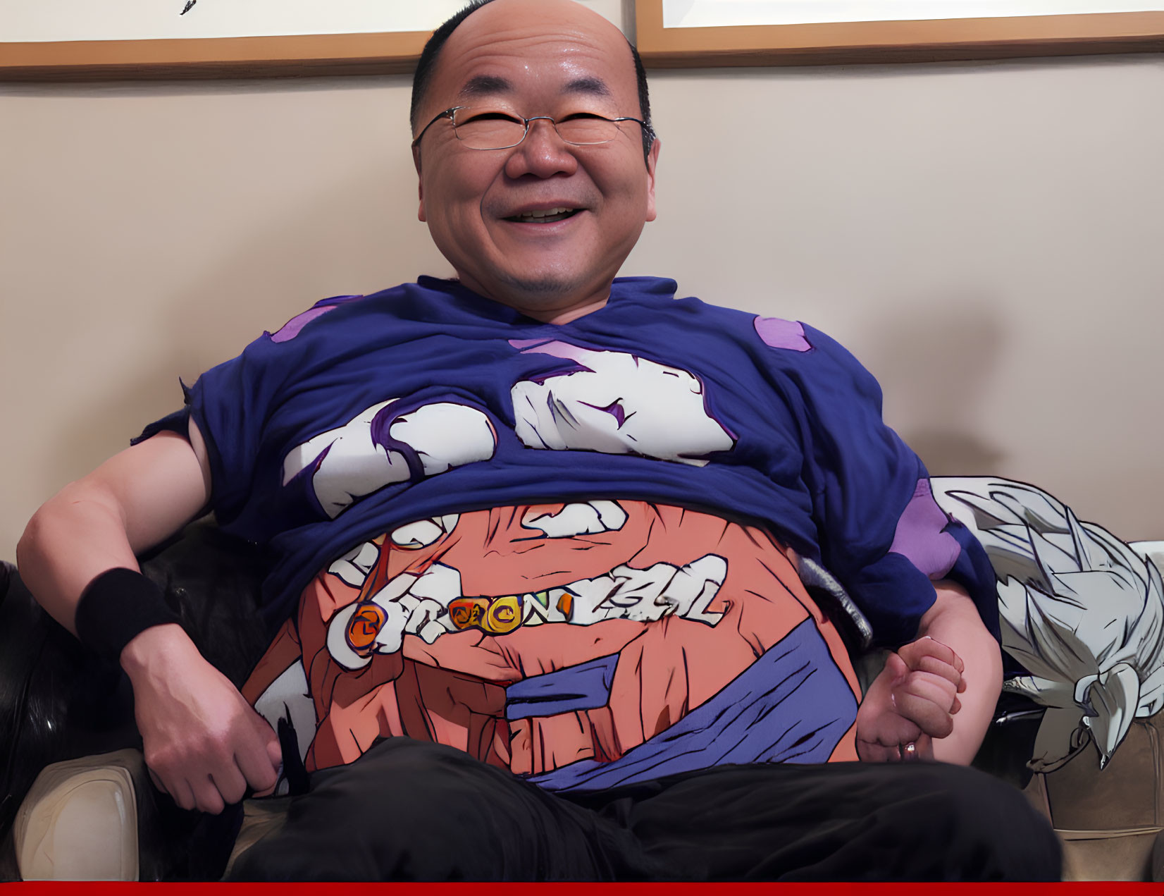 Smiling person in Dragon Ball Z Goku t-shirt on couch with artwork