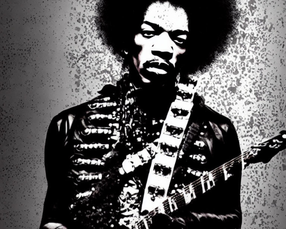 Monochrome image of man with afro holding guitar