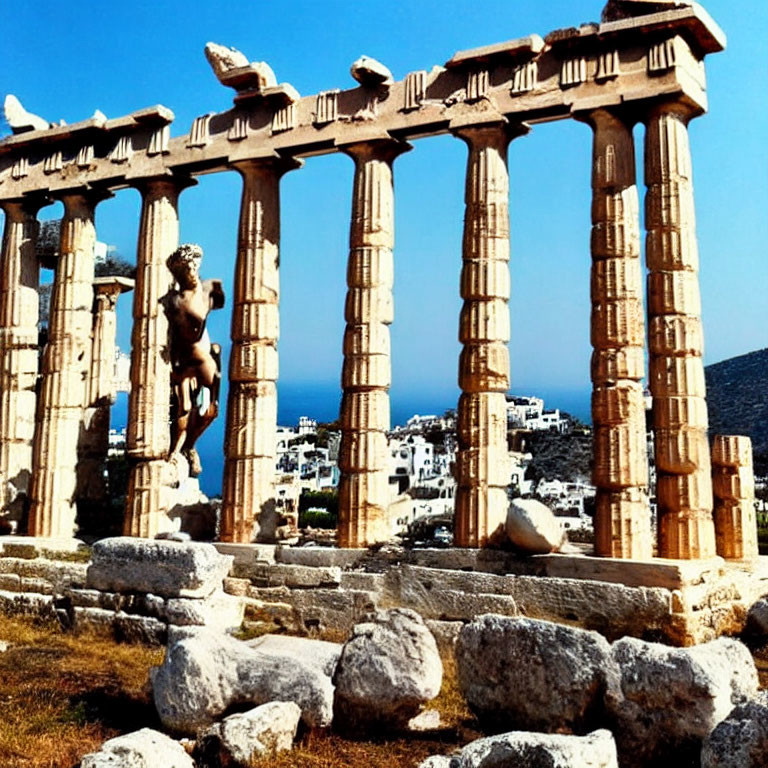 Ancient Greek temple ruins with Doric columns by the sea and town in the background